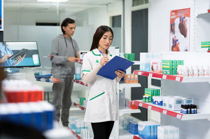 Pharmacy staff member next to shopping customer